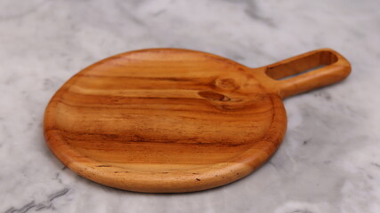Wooden board for cutting on white marble background