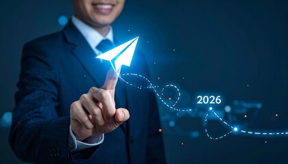 Smiling businessperson pointing at glowing paper airplane icon with dotted path to “2026” on dark tech background.