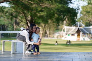 Asian mother and son bonding in outdoor park
