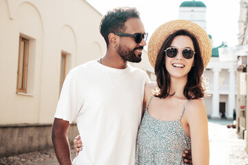 Smiling beautiful woman and her handsome boyfriend. Woman in casual summer clothes. Happy cheerful...