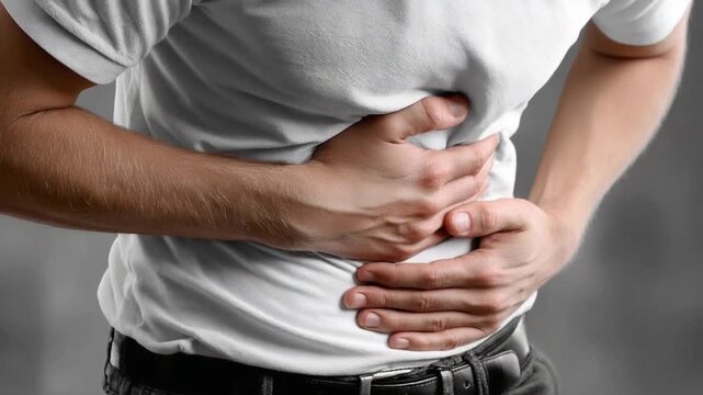 Stomach Pain: A man clutches his abdomen in discomfort, highlighting the visceral experience of abdominal pain, revealing vulnerability and distress.