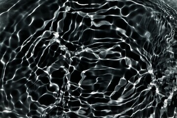 Blue water with ripples on the surface. Defocus blurred transparent blue colored clear calm water surface texture with splashes and bubbles. Water waves with shining pattern texture background.