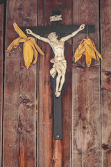 Crucifix with Jesus between two corn cobs. Rural tradition on Val Gardena, Italy