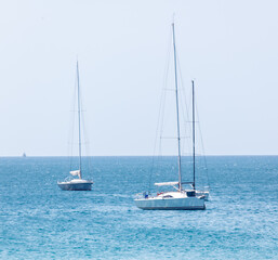 Fototapeta premium Two sailboats are in the water