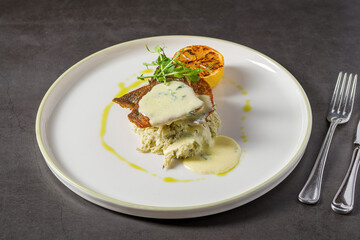 Grilled sea bream fillet with creamy sauce and elegant plating