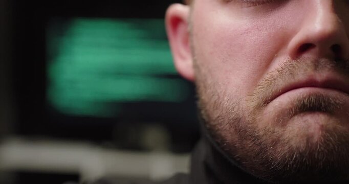 Cinematic close-up of an unhappy man reacting to AI-related stress, with a blurred computer interface in the background&mdash;concept for tech anxiety, workplace pressure, and digital overload.