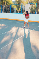 Passion for the game, Asian teen smiling girl in red shirt enjoying time on outdoor court, vertical
