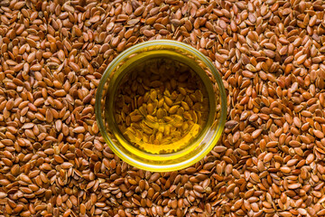 Brown linseed or flaxseed and oil. Healthy flax seed. Top view.