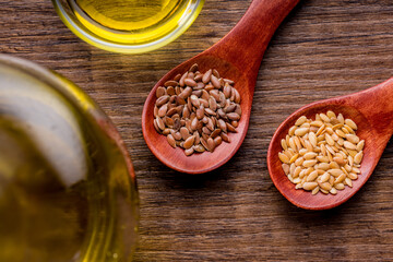 Brown and gold linseed or flaxseed . Healthy flax seed on wooden spoon on wooden table. Top view.
