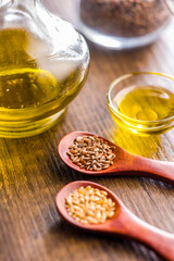 Brown and gold linseed or flaxseed . Healthy flax seed on wooden spoon on wooden table.