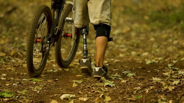 Man with prosthetic leg  riding a bike