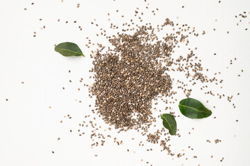 Dry chia seeds scattered on light gray white background top view. Food background, healthy eating concept, superfood. Healthy organic chia seeds rich in omega-3, protein, vitamins and minerals