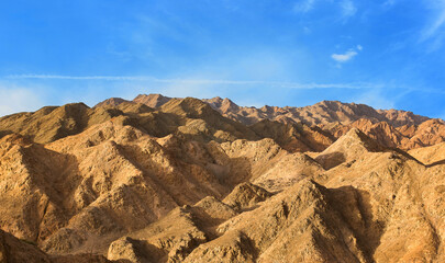 extreme terrain of Moroccan desert mountain dunes aerial drone view photography from above wallpaper pattern beauty of nature landscape panorama horizon line with blue sky background