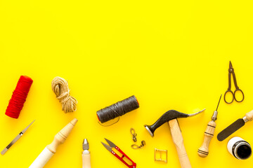 Leather crafting tools in tailor or shoemaker shop, top view