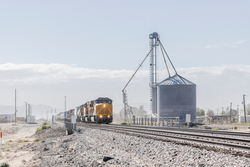 Dusty rural farming landscape and an approaching train