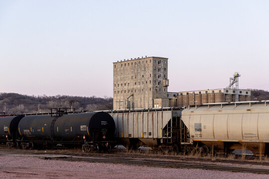 Railroad freight cars sitting near grain elevator