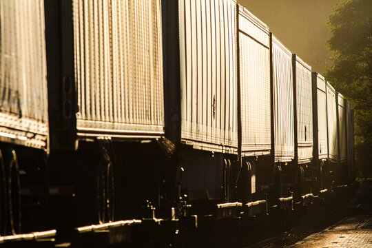 Truck trailers on train cars compressed view last light