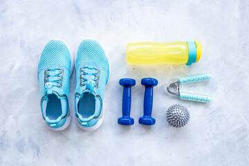 Sports equipment flat lay. Sneakers and dumbbells for fitness