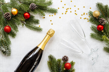 Christmas bottle of champagne with two glasses and fir tree branches, top view. Happy New Year and Merry Christmas decoration