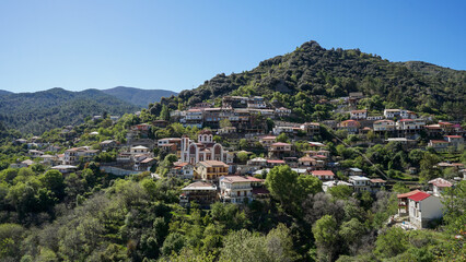 Pedoulas village with orthodox church in mountains aerial panoramic view, Cyprus