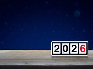 Retro flip clock with 2026 text on wooden table over fantasy night sky and moon, Happy new year 2026 cover concept