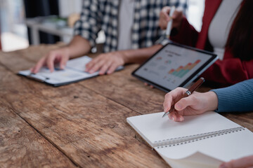 Business professionals collaborating and analyzing data during a meeting