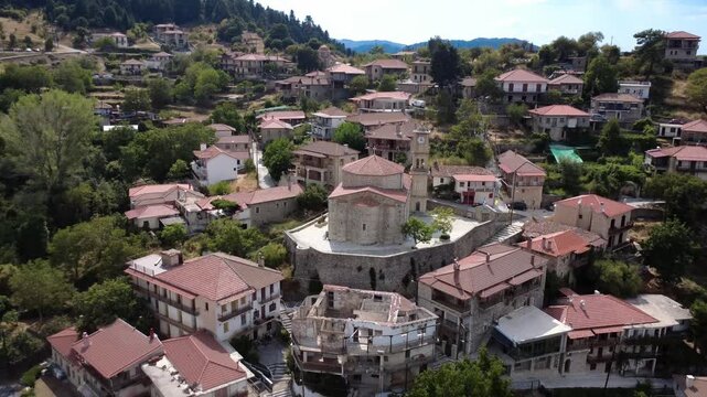 Traditional stone Orthodox church on a cliff in a Greek mountain village.