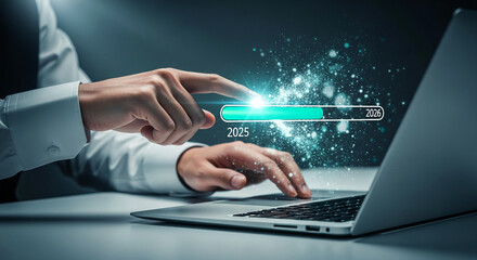 Human finger touching loading bar on a laptop, progressing from 2025 to 2026, representing advancement, progress, and digital transformation concept