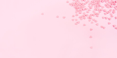 Pink background with tiny hearts. Valentine's day concept. Top view.