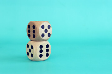 Stack of two wooden dice on blue background