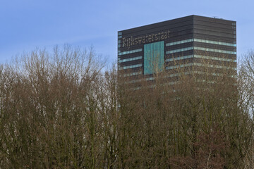 The tall Rijkswaterstaat office building in Utrecht rising above the trees, headquarters of the Dutch Ministry of Infrastructure and Water.