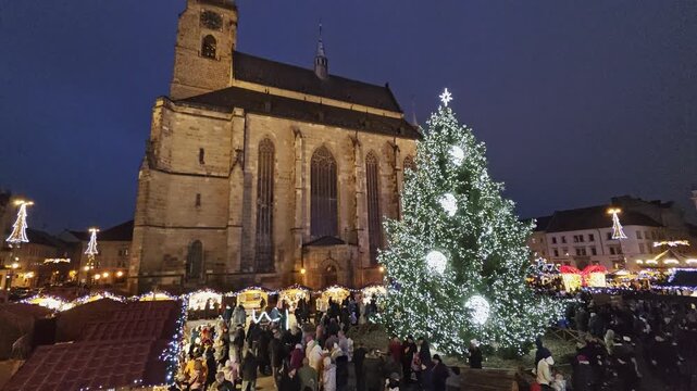 Festive Christmas market in Plzen with illuminated kiosques, holiday decorations and cathedral view on the historic main square