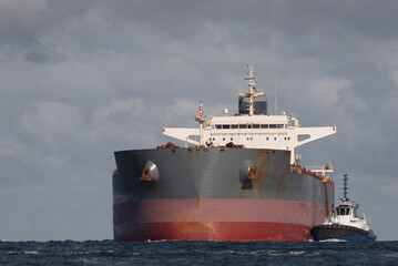 MARITIME TRANSPORT - A large bulk carrier is sailing into sea port
