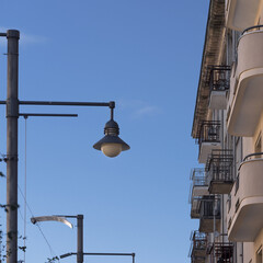 ARCHITECTURE - A classic modernist tenement house and stylish street lamp in Gdynia