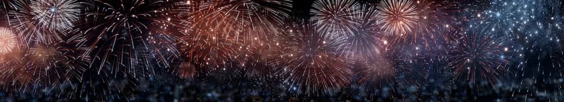 vibrant fireworks bursting in red, blue, and white across night sky in festive celebration