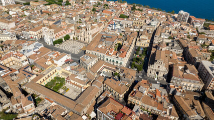 Aerial view of the historic center of Acireale, in the province of Catania, Sicily, Italy. In the center of the town are the city's main churches: the Duomo, Santa Maria, and San Sebastiano. Sunny day