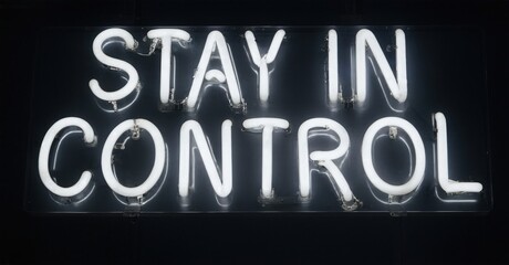 Bright neon sign displays message Stay In Control against dark background. Simple typography, modern aesthetic, impactful statement.