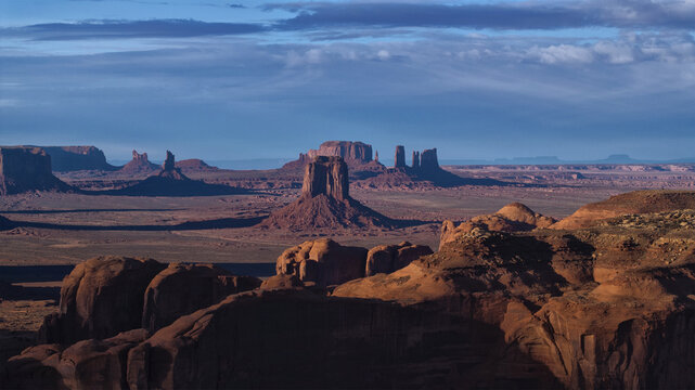 Aerial view of majestic sandstone buttes piercing the horizon under a vast sky, Monument Valley, Arizona, United States.