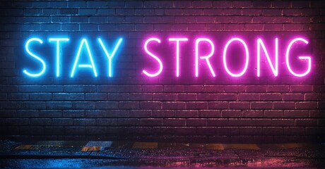 Fototapeta premium Neon sign displays Stay Strong against brick wall. Dark background emphasizes vibrant blue, purple hues. Inspiring message.