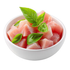 Diced raw protein with fresh green basil leaves in a white bowl