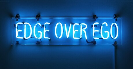 Fototapeta premium Bright blue neon sign displays text EDGE OVER EGO against dark wall. Minimalist design, modern aesthetic, simple presentation.