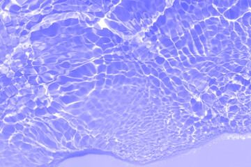 Purple water bubbles on the surface ripples. Defocus blurred transparent pink colored clear calm water surface texture with splash and bubbles. Water waves with shining pattern texture background