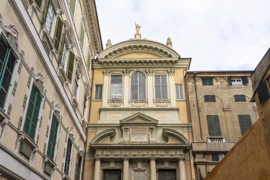 View of Ex Saint Gerolamo and Francesco Saverio church facade rises in golden hues, Genoa, Liguria, Italy.