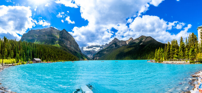 Tourists canoeing on lake louise in banff national park, canadian rockies
