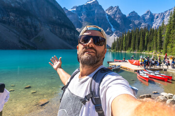 Tourist taking selfie at moraine lake in banff national park