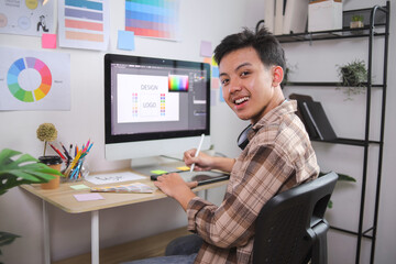 Young Graphic Designer Smiling at Camera While Taking Break With Coffee From Creating Brand Logo