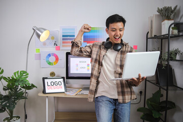 Happy Young Professional With Triumphant Expression and Headphones on Neck