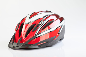 Red black and white bicycle helmet isolated on white background