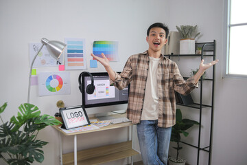 Young Man Standing Proudly at His Organized Graphic Design Desk