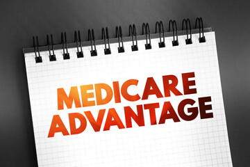 Fototapeta premium Medicare Advantage - type of health insurance plan that provides Medicare benefits through a private-sector health insurer, text on notepad, concept background